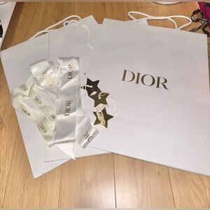 Dior white pebble shopping bag with gold stars and ribbons